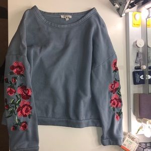 Blue sweatshirt with red/pink roses on the sleeves